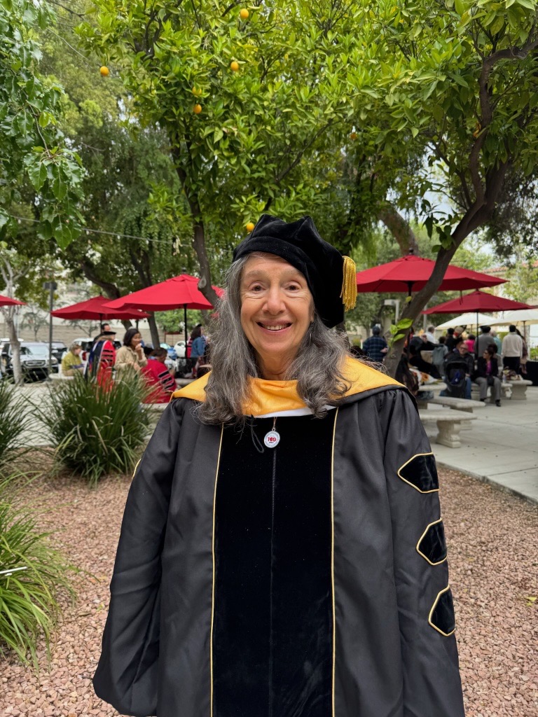 Wendy Martin stands in regalia at CGU