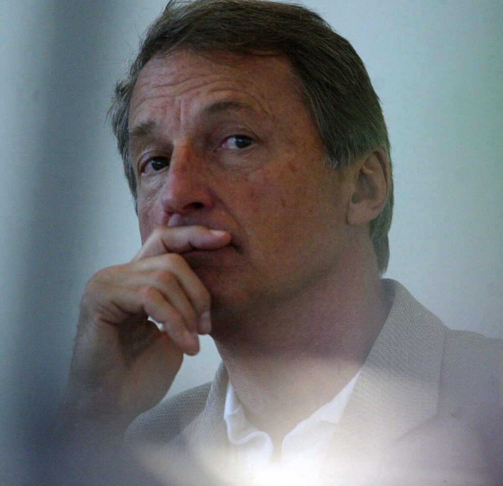 Robert klitgaard looks into the distance with a raised hand to his chin.
